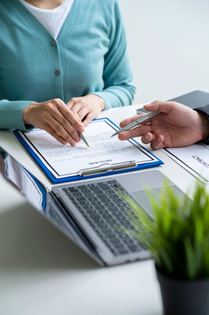 Human resources manager conducting job interview with applicant in the office, Candidate with resume
