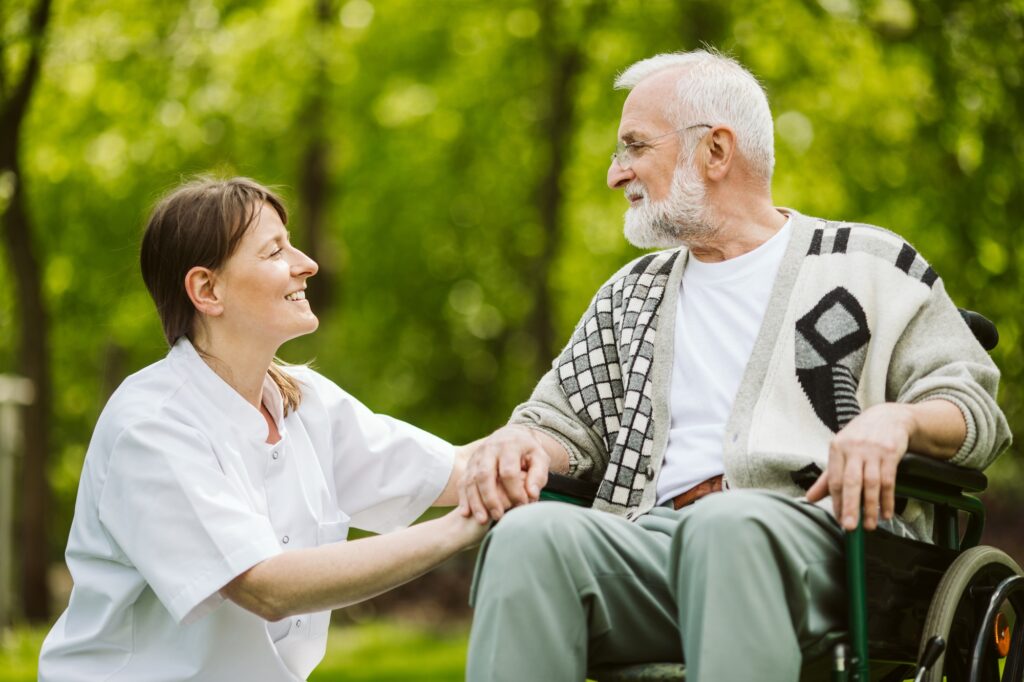 Nurse and patient in the garden of modern senior home with daily care